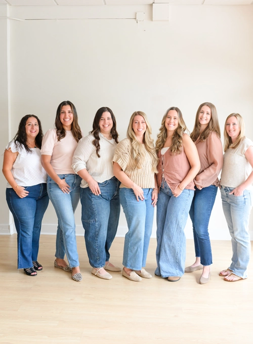 The entire team smiling.