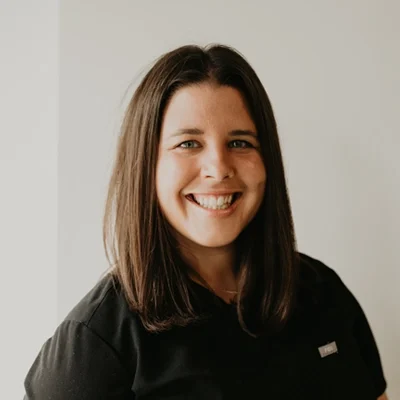 Chiropractor Waldwick NJ Emily Leibforth Meet The Team Emily Leibforth smiling in a black shirt.